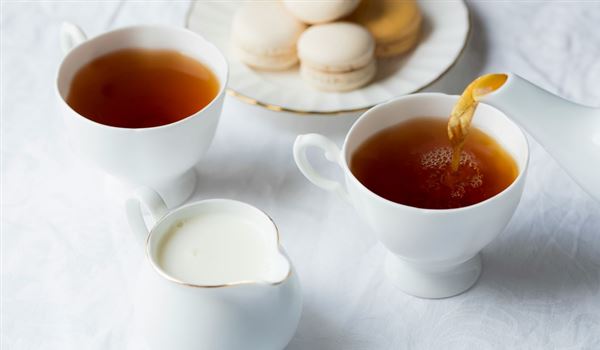 tea being poured into china cups