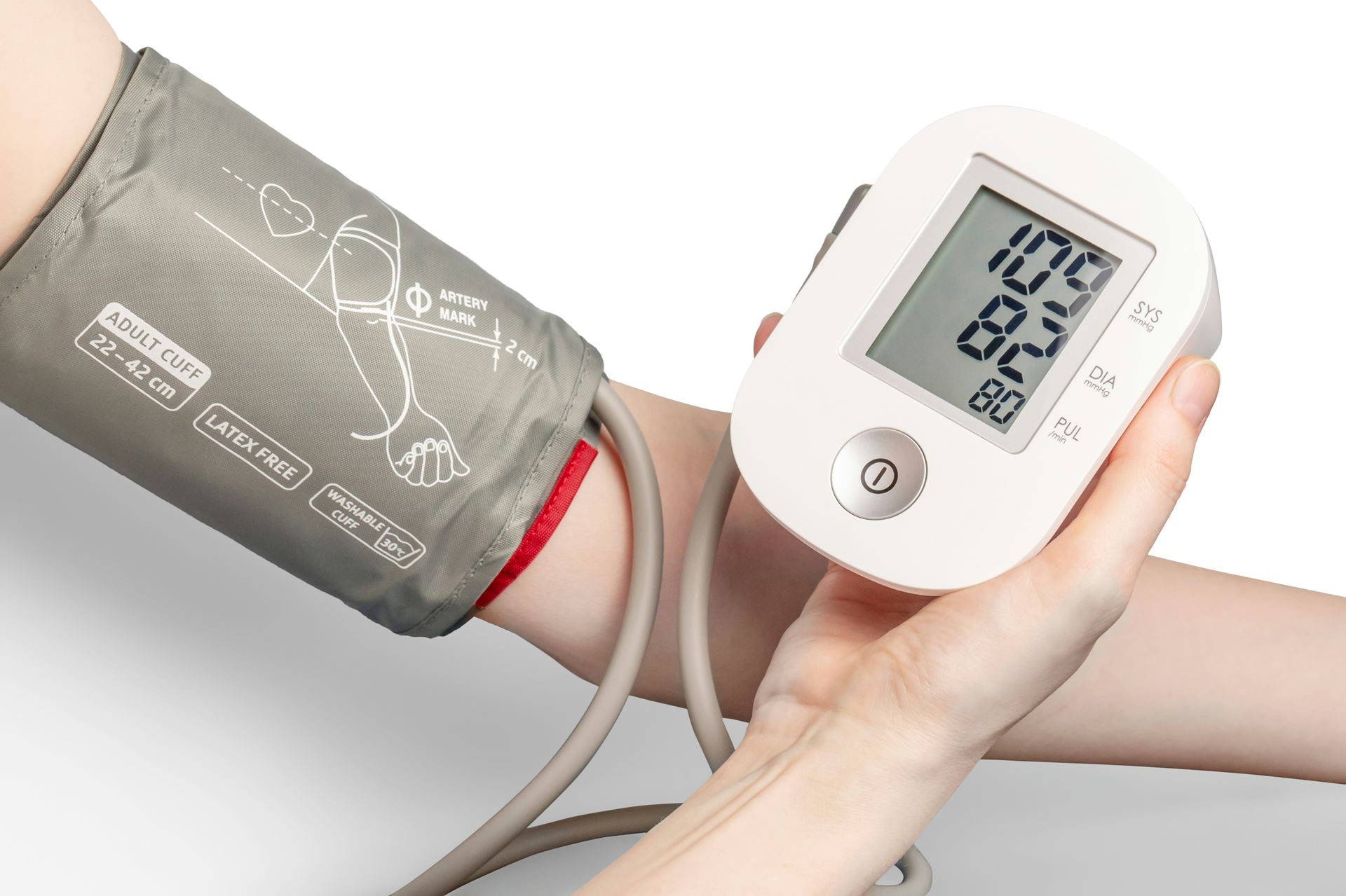 a person with a blood pressure monitor in their hand and a cuff on their arm