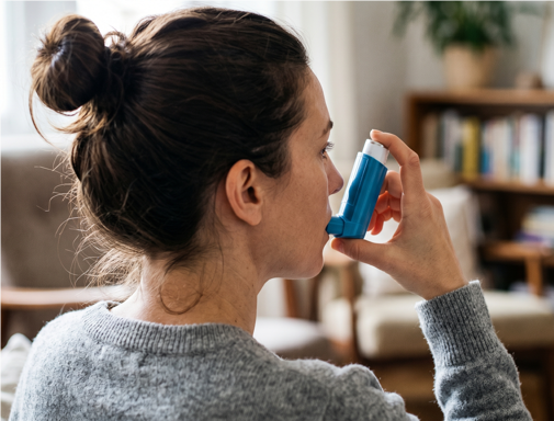 a woman using a blue inhaler