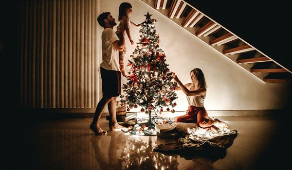 a family decorating a Christmas tree